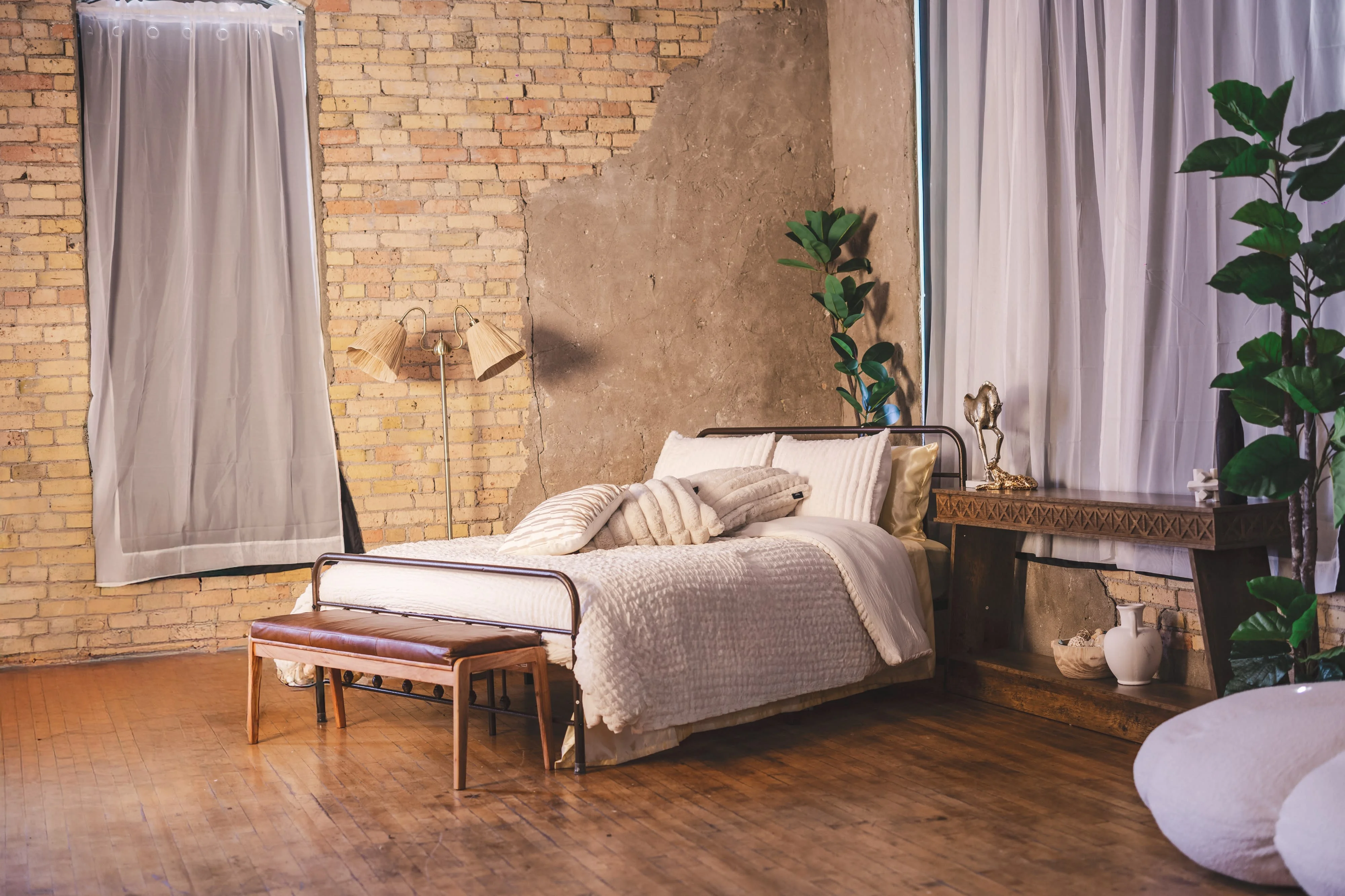 Bedroom set with linen bedding and a bench