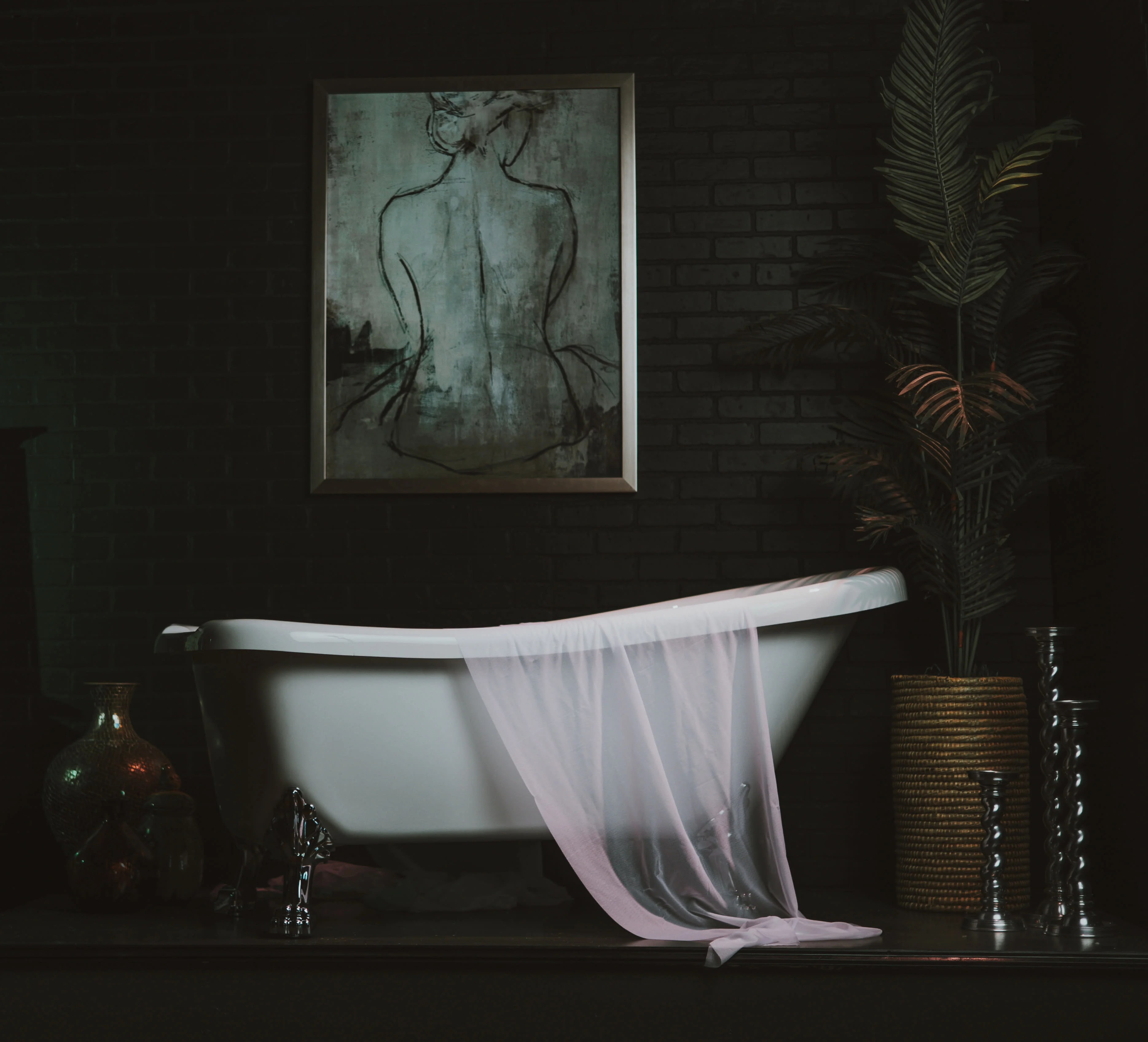 Clawfoot tub set with draped fabric in low light